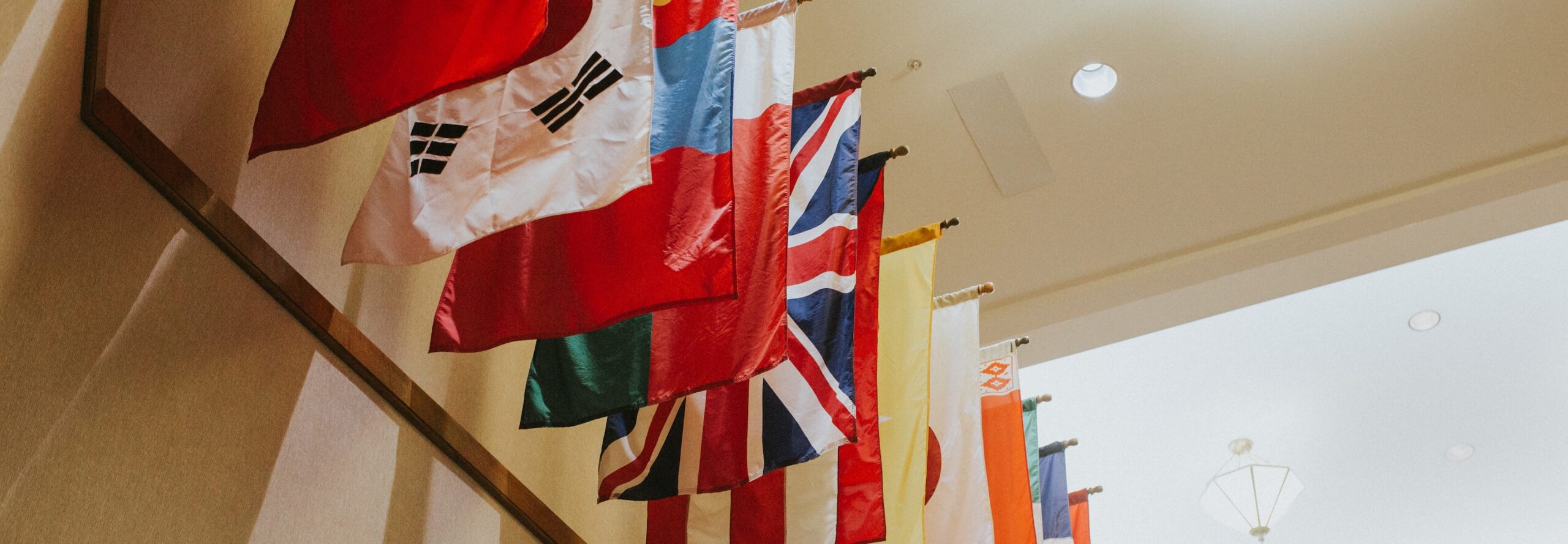 flags of the nations hanging in an academic building